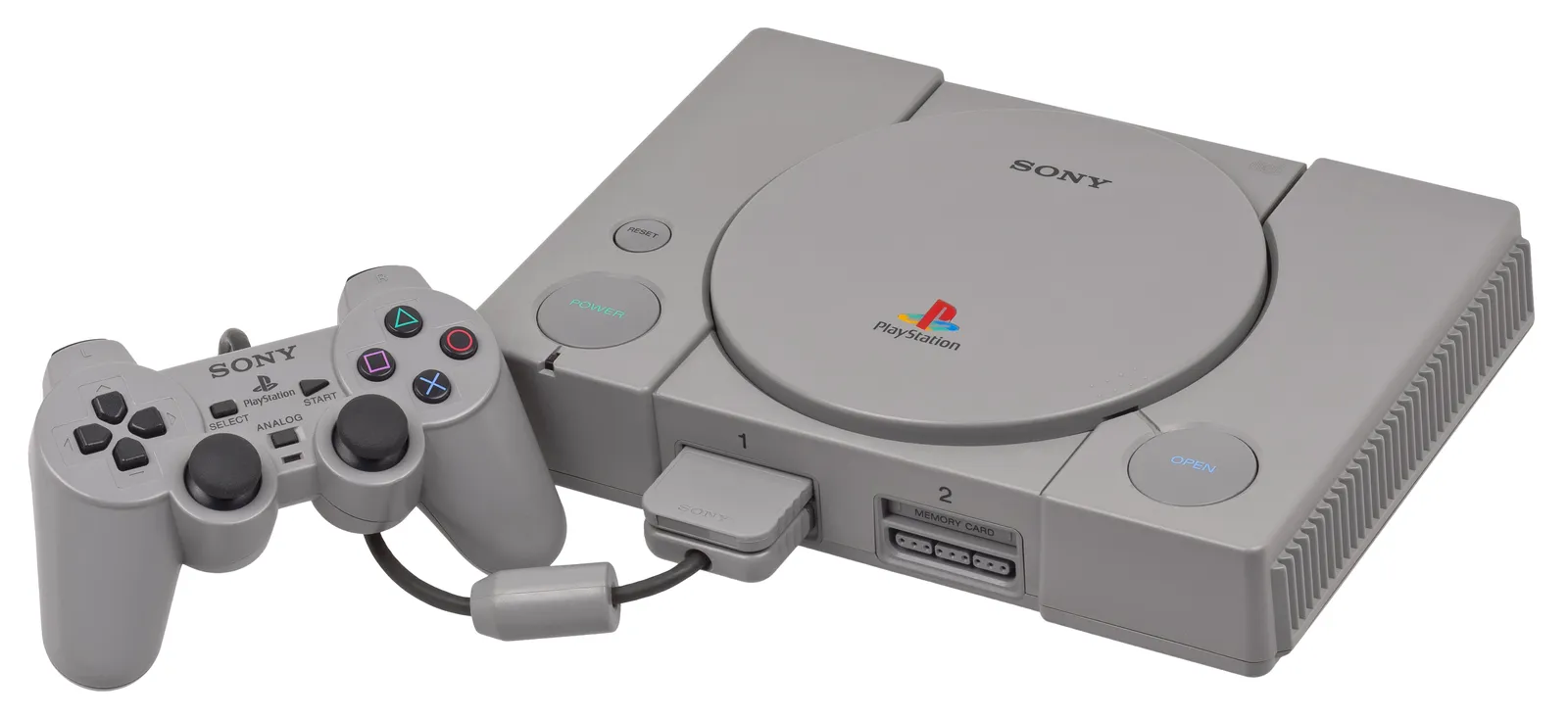 The original grey Sony PlayStation console with a DualShock controller plugged in.